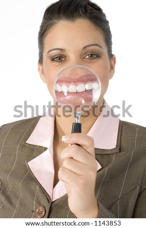 Beautiful Hispanic business woman with magnifying glass in front of mouth.  Created in camera... not photoshop.  Shot in studio over white.