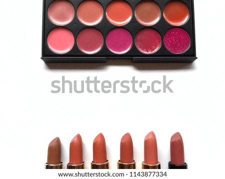 Colorful Lipstick set in palette and bar on white background.