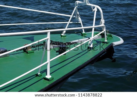   Bow of a green warship against the blue sea with  anchor at the bow. copy space, selective focus, narrow depth of field                               