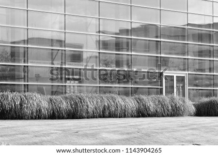 Modern office building wall made of steel and glass. Black and white.