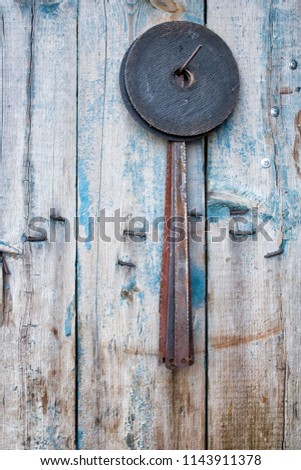 Saw blades and circular disks hang on the door