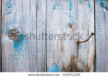 old wooden boards. protruding nail in the board, old fence