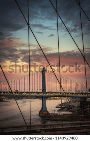 Amazing landscape of the Manhattan bridge at pink sunset in New York from the Brooklyn bridge