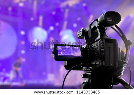 Video production covering event on stage by professional video camera Royalty-Free Stock Photo #1143933485