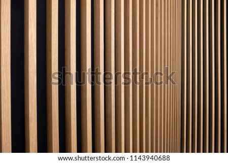 Wall decorated with wooden planks. Futuristic geometric wall design. Wood texture.