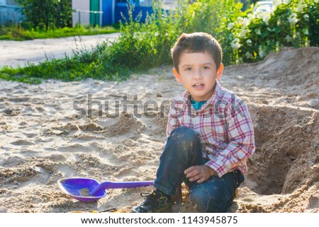 boy 4 years old playing with sand