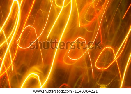 Blurred colorful lights in motion. Abstract background in orange and yellow tones