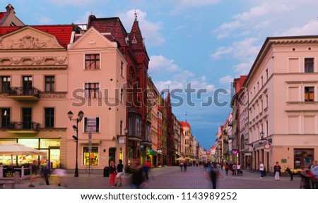 Night view of Torun streets and building illuminated at dusk, old town in Poland