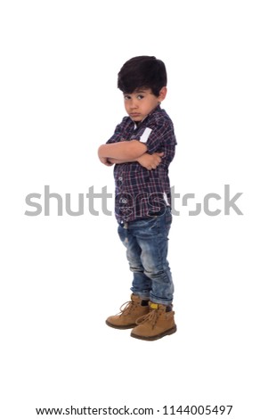 upset kid crossed arms looking to the camera in casual wear and staring , isolated in white background