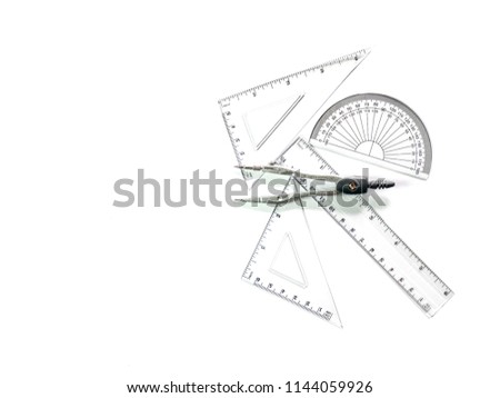 Compass set ,Half circle , Triangular ruler, ruler, and roundabout. Construction equipment on a white floor.