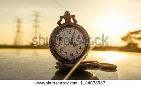 Picture of a classic pocket watch during sunset