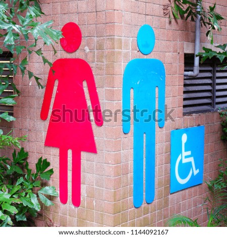 Public toilets entrance with male and female signs and disable sign