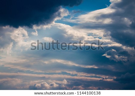 beautiful picture, the contrast of clouds with sun rays