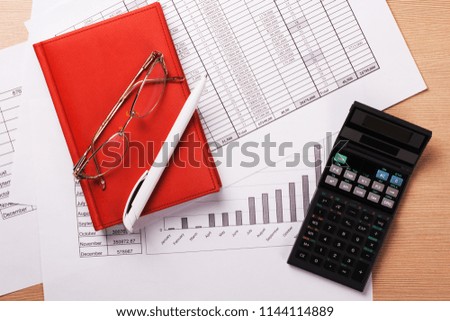 Business finance document with notebook. Office table