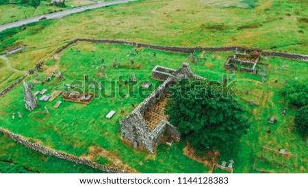 Ruins of an old church and cemetery in Scotland - aerial view