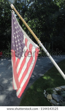 An American flag in the sunlight on a pole 