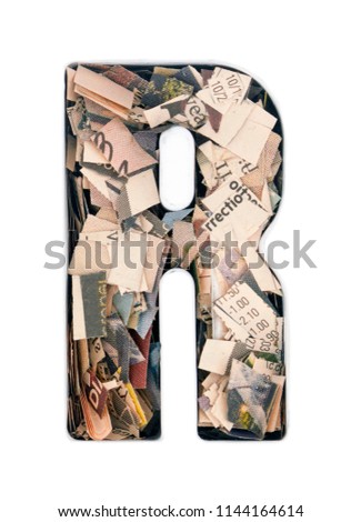 financial news  newspaper cut up into confetti  to make  the captal letter,R