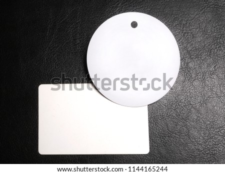 Round badge and business card on a black background. Corporate identity template