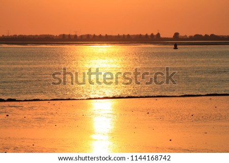 beautiful orange sunset at the beach and the sea