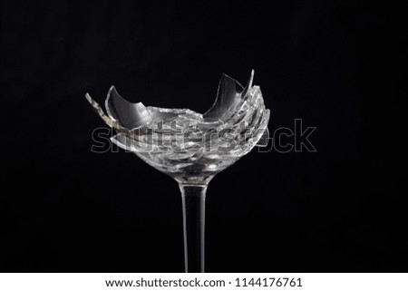 Broken glass in front of black background photographed under the Moto glass shards cocktail        
              