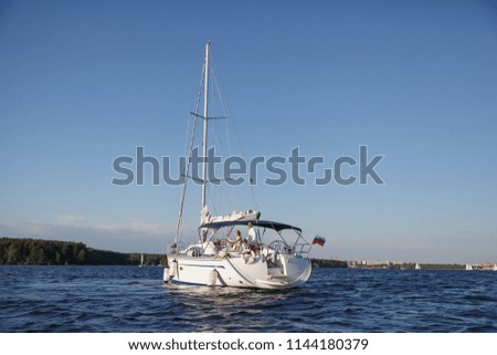 Happy young people. Young couple on a yacht. Couple in love resting on the sea. Sunny day.