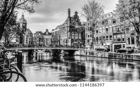 Сanal and embankments of Amsterdam city. Black-white photo.