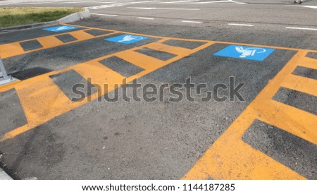 Wheelchair Handicap Sign on dark asphalt road street background- handicap parking place

