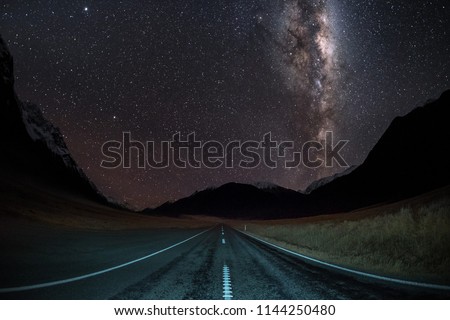 Milky Way Galaxy shot right in the middle of a road. There are millions of stars in the night sky. It is amazing to look at. The milky way galaxy center is bright. Royalty-Free Stock Photo #1144250480