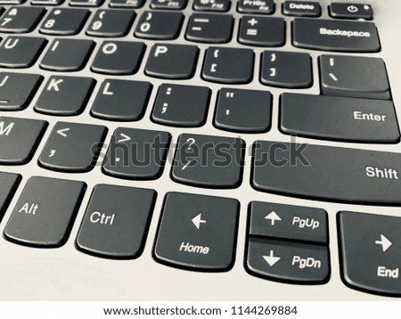 Keyboard / A computer keyboard is a typewriter style device which uses an arrangement of buttons or keys to act as mechanical levers or electronic switches Royalty-Free Stock Photo #1144269884