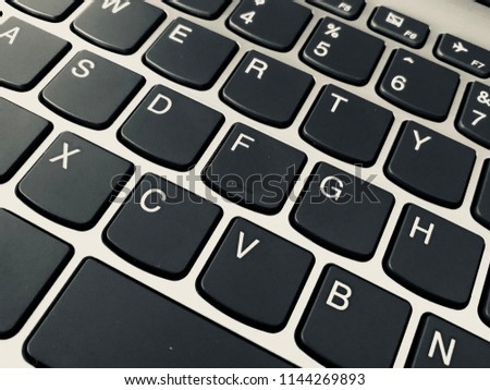 Keyboard / A computer keyboard is a typewriter style device which uses an arrangement of buttons or keys to act as mechanical levers or electronic switches Royalty-Free Stock Photo #1144269893
