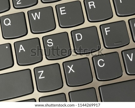 Keyboard / A computer keyboard is a typewriter style device which uses an arrangement of buttons or keys to act as mechanical levers or electronic switches Royalty-Free Stock Photo #1144269917