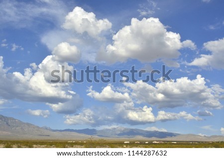 billowy white and gray clouds over desert in Pahrump, Nevada, USA Royalty-Free Stock Photo #1144287632