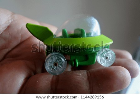 green car toys in big hands