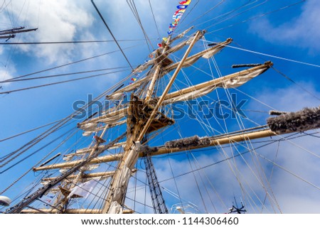 Cable ladders, mast and ropes of a sailing ship against the blue sky. Concept of travel, adventure and sea. Photo made on the sailboat "Nadezda". Russia, Vladivostok.