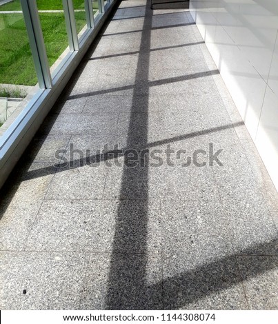 The sun shines through the glass, causing a shadow.