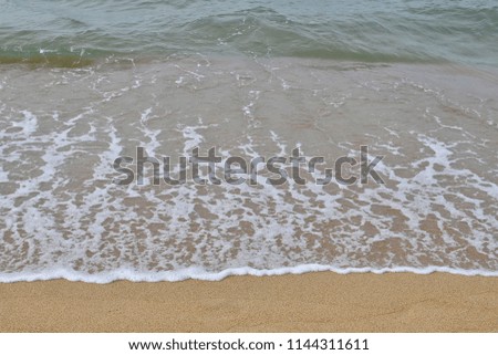 Soft wave on sandy beach.