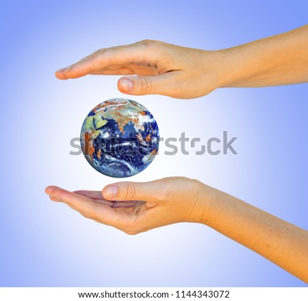 Planet earth on palm.Elements of this image furnished by NASA