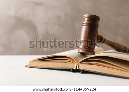 Wooden gavel and book on table. Law concept