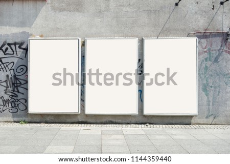 Thee empty advertising billboards on the wall of building Royalty-Free Stock Photo #1144359440