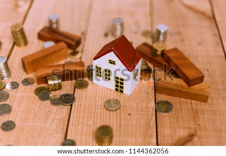 Mortgage concept. Wooden house model and wooden background