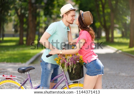 Happy young couple with bicycle in the sity. Love, relationship, romance concept.