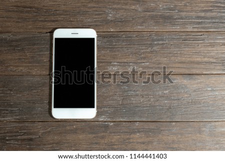 empty smartphone or tablet on wooden table