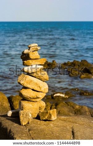 Stack stone balance with ocean skyline abstract background