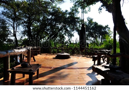 Okavango Delta: The wooden deck to the fireplace in the wilderness at Jao Wilderness Camp