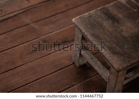 brown short old chair wooden vintage style on wooden background with copy space .