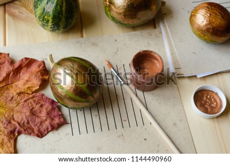 painting of green decorative pumpkin in bronze color, stock photo image