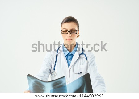 woman holds x-ray pictures doctor injury                               