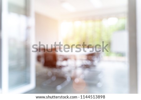 Blurred image of meeting room in the modern office, evening time with sunlight - ideal for presentation background.