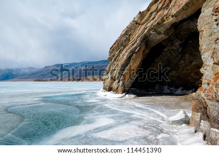 outdoor view of cave at frozen baikal lake in winter Royalty-Free Stock Photo #114451390