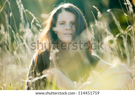 Beautiful young woman enjoys last warm day outside.
